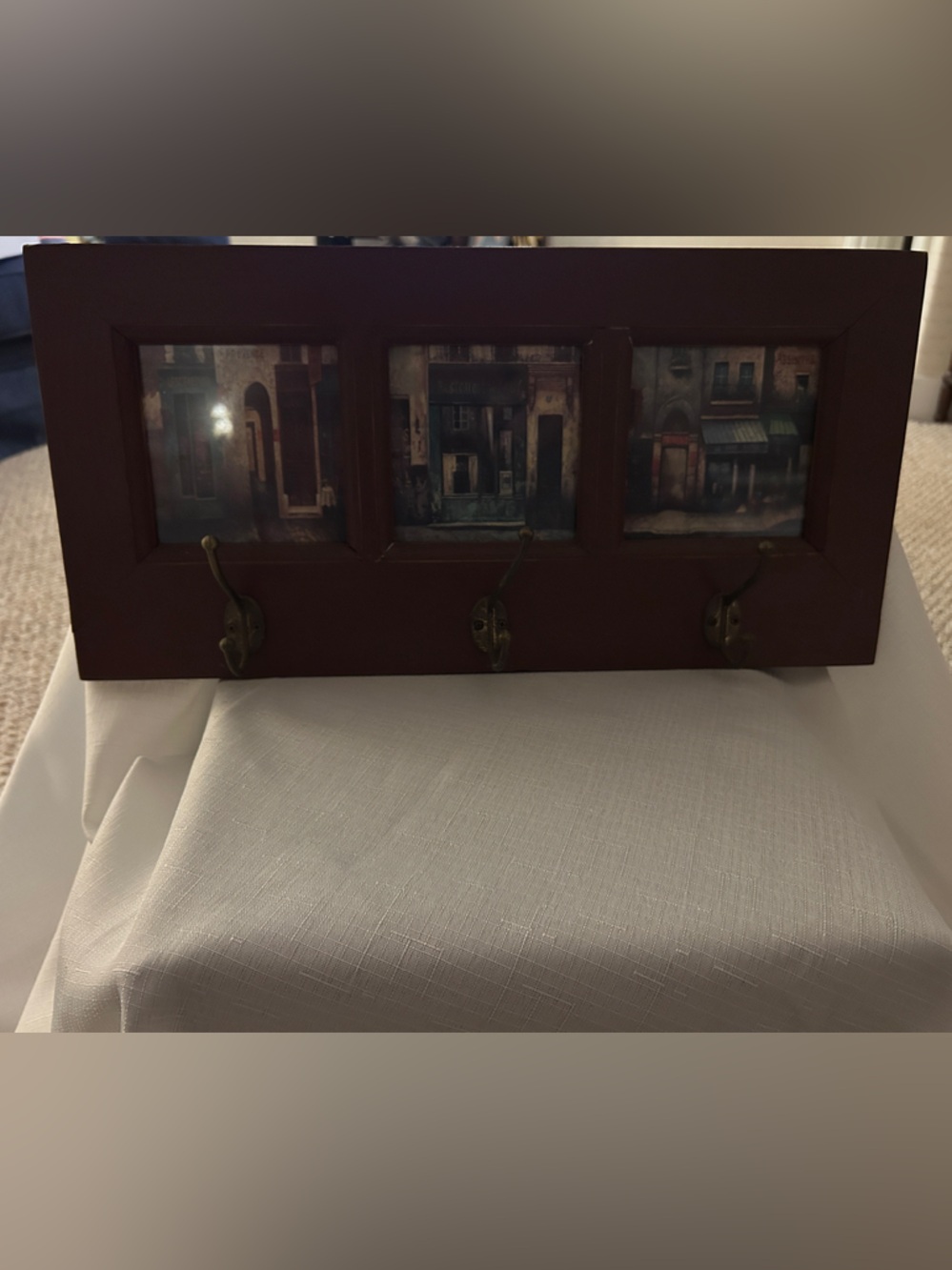 Wall-Mount Coat Rack with Brown Frame and Vintage Artwork